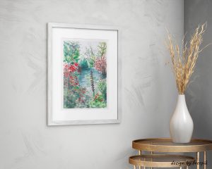 Décoration d'intérieur avec un cadre dans lequel se trouve une aquarelle représentant le jardin de Giverny