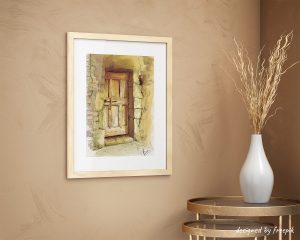 Décoration d'intérieur avec un cadre dans lequel se trouve une encre représentant la porte en bois d'une vieille maison.