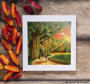 Décoration d'intérieur avec un cadre dans lequel se trouve un dessin représentant une jeune femme et son chat chargés de fruits et légumes qui partent en remerciant la nature.