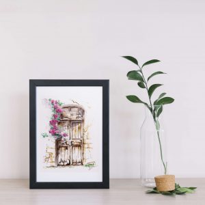 Dessin à l'encre et à l'aquarelle représentant une porte d'une maison abandonnée à côté de laquelle pend des fleurs grimpantes, encadré et présenté à côté d'une plante @Ysae illustrations
