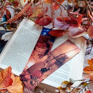 Marque-page d'Halloween avec citrouille présenté en situation dans un livre, dans une décoration automnale @ Ysae illustrations