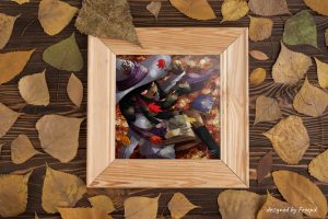 Dessin numérique dans un cadre représentant une jeune sorcière noire aux yeux rouges en uniforme d'université, assise dans les feuilles d'automne en train de regarder un livre de gravures anciennes ©Ysae illustrations