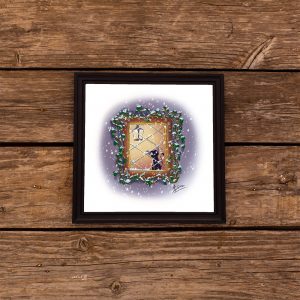 Impression laser présentée dans un cadre d'un dessin numérique représentant un chat à une fenêtre regardant la neige tomber ©Ysae illustrations