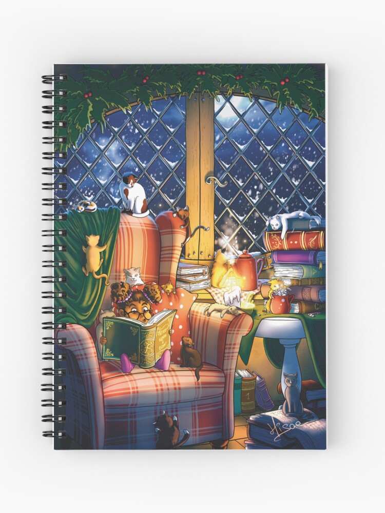 Carnet à spirales dont la couverture est un dessin numérique représentant une petite fille qui lit un conte de Noël à tous ses chats et chatons, devant une grande fenêtre, pendant qu'il neige dehors ©Ysae illustrations